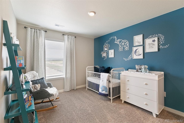 bedroom featuring carpet and a crib