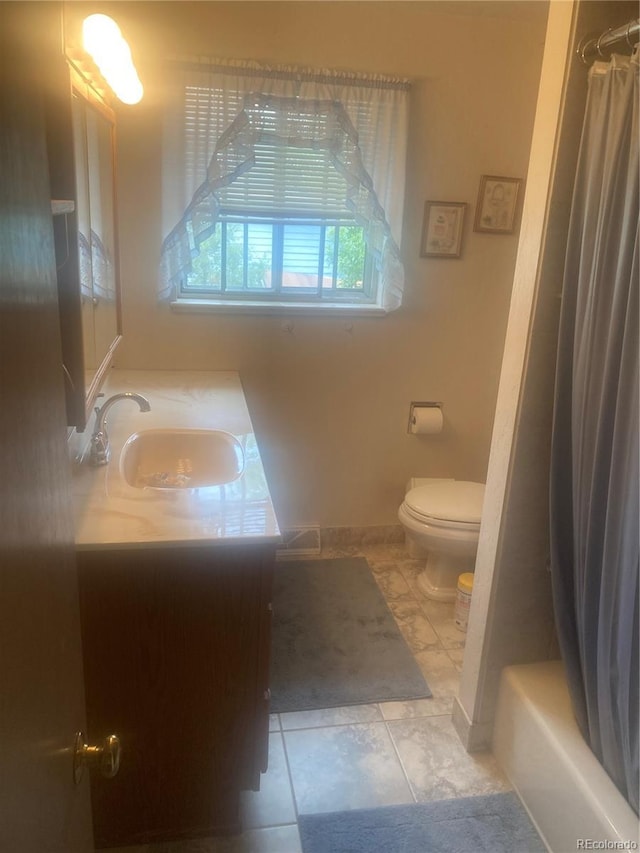 14751 E 24th Ave, Aurora, CO 80011 - bathroom featuring toilet, vanity, shower / bath combination with curtain, and tile patterned flooring