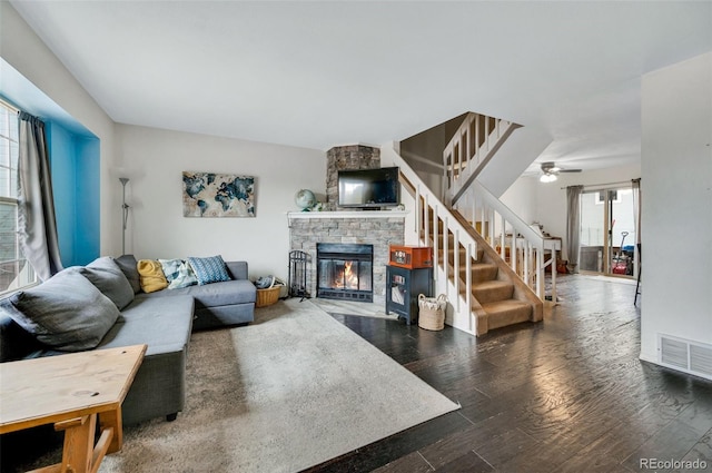 3831 Smoke Tree Dr, Colorado Springs, CO 80920 - living area with a fireplace, a ceiling fan, wood finished floors, visible vents, and stairway