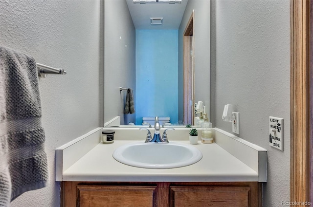 3831 Smoke Tree Dr, Colorado Springs, CO 80920 - bathroom with vanity and a textured wall