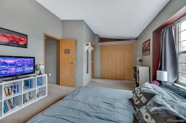3831 Smoke Tree Dr, Colorado Springs, CO 80920 - bedroom featuring a closet, carpet, vaulted ceiling, and a textured ceiling