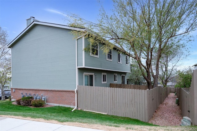 3831 Smoke Tree Dr, Colorado Springs, CO 80920 - exterior space featuring a yard, brick siding, fence, and a chimney