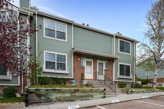 3831 Smoke Tree Dr, Colorado Springs, CO 80920 - view of property with brick siding, entry steps, and uncovered parking
