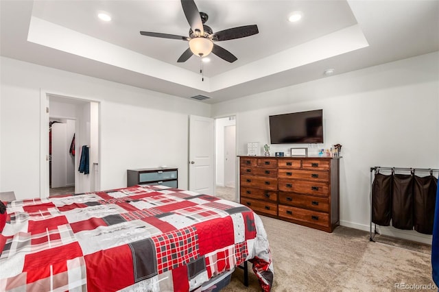 carpeted bedroom featuring visible vents, recessed lighting, a raised ceiling, and a ceiling fan