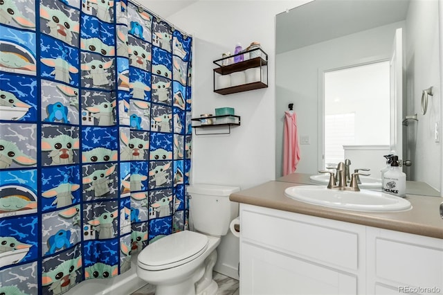 bathroom featuring curtained shower, toilet, and vanity