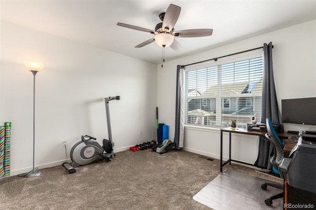 carpeted office with visible vents, a ceiling fan, and baseboards