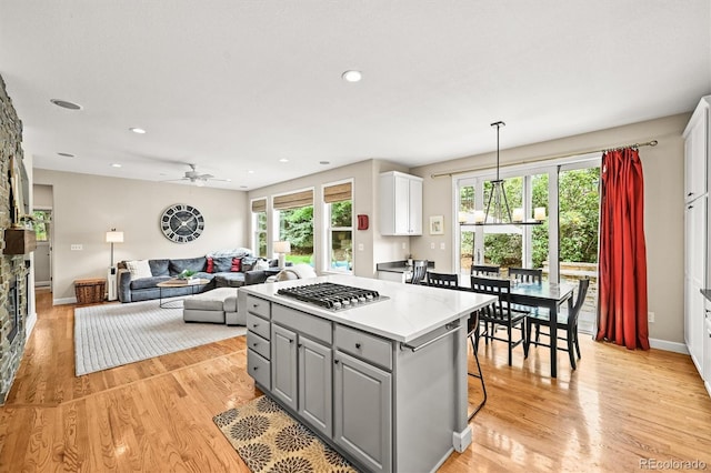 6105 W Long Dr, Littleton, CO 80123 - kitchen featuring stainless steel gas stovetop, gray cabinets, plenty of natural light, a ceiling fan, and recessed lighting