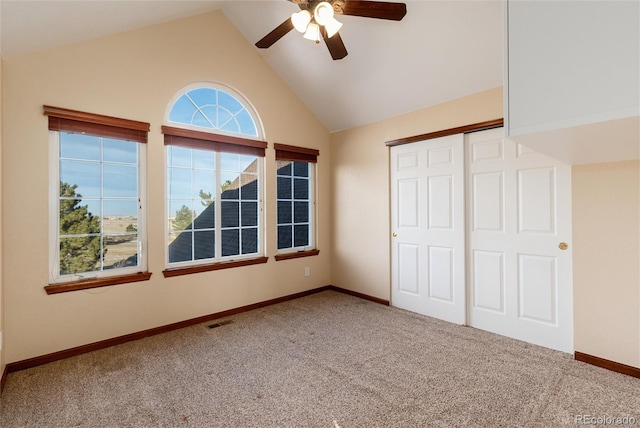 unfurnished bedroom featuring a closet, visible vents, carpet flooring, vaulted ceiling, and baseboards