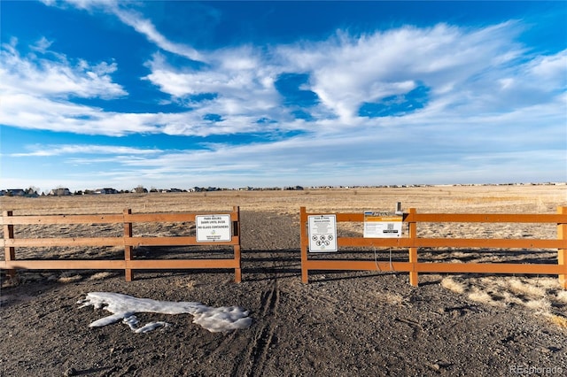 view of yard featuring fence and a rural view