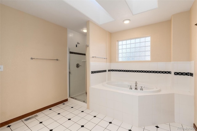 full bathroom featuring a stall shower, a garden tub, visible vents, and baseboards