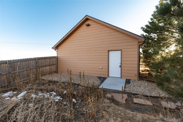 view of outbuilding with fence