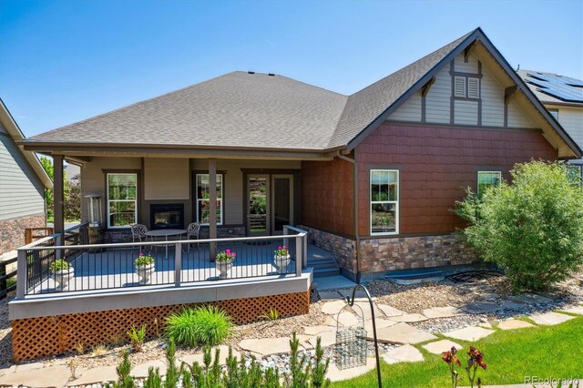 24322 E Mineral Dr, Aurora, CO 80016 - rear view of property featuring roof with shingles and stone siding