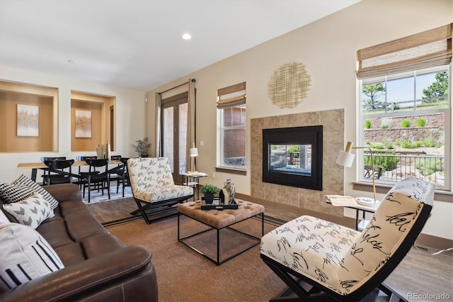 24322 E Mineral Dr, Aurora, CO 80016 - living area with wood finished floors, a tile fireplace, and recessed lighting