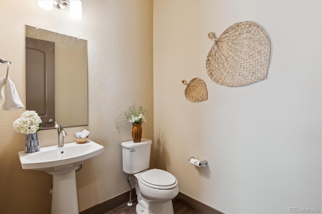 24322 E Mineral Dr, Aurora, CO 80016 - half bathroom featuring toilet and wood finished floors