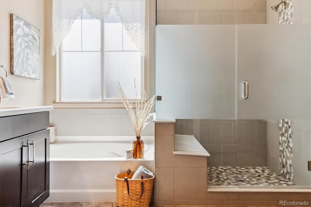 24322 E Mineral Dr, Aurora, CO 80016 - bathroom featuring a stall shower, a bath, and vanity