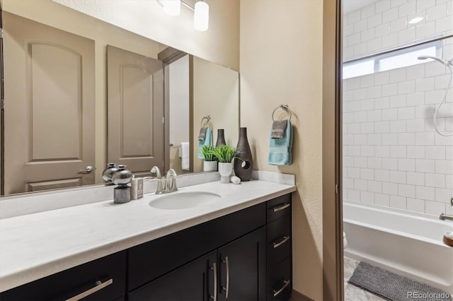 24322 E Mineral Dr, Aurora, CO 80016 - bathroom featuring vanity, tub / shower combination, and a textured wall
