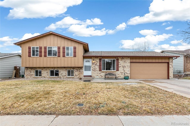 split level home with brick siding, board and batten siding, concrete driveway, and a garage