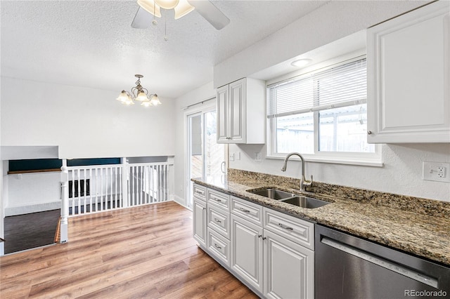 kitchen with a sink, light wood-type flooring, dishwasher, and white cabinets