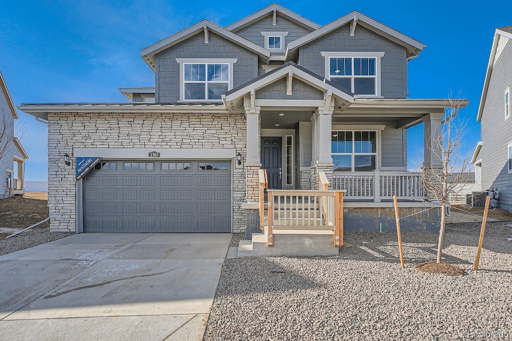 view of front of home with a garage and central air condition unit