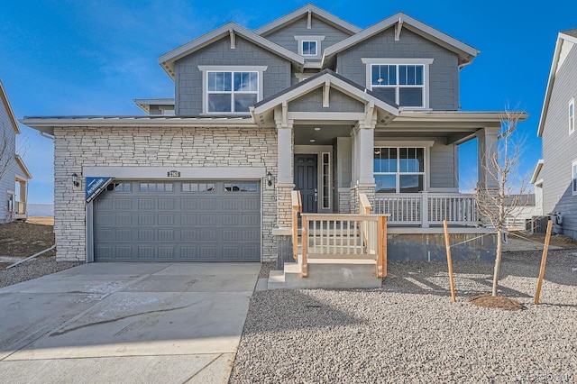 view of front of home with a garage and central air condition unit