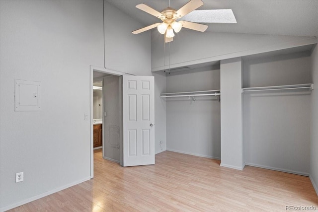 unfurnished bedroom with ceiling fan, a closet, light hardwood / wood-style floors, and vaulted ceiling