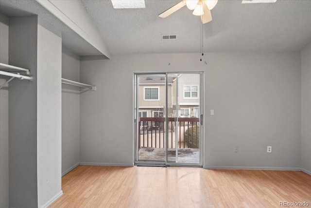 interior space with hardwood / wood-style floors, ceiling fan, and a textured ceiling