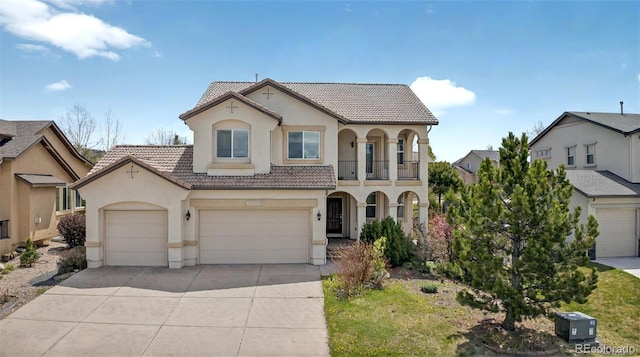 16043 Bridle Ridge Dr, Monument, CO 80132 - mediterranean / spanish-style house featuring a tile roof, stucco siding, and driveway