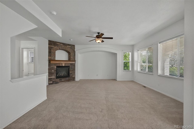 16043 Bridle Ridge Dr, Monument, CO 80132 - unfurnished living room featuring ceiling fan, a fireplace, carpet floors, and baseboards