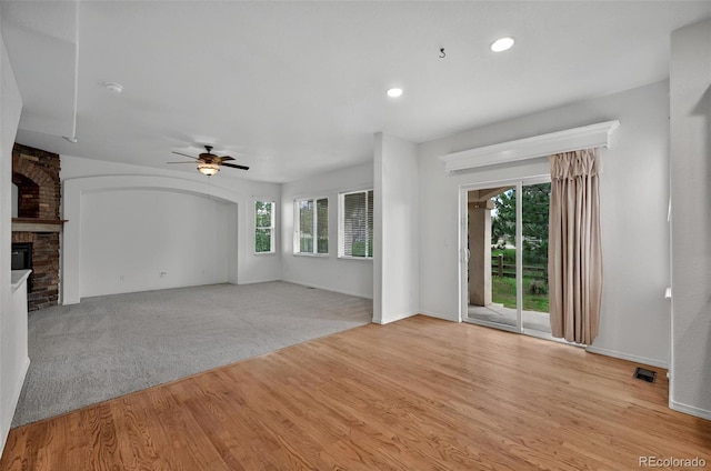 16043 Bridle Ridge Dr, Monument, CO 80132 - unfurnished living room featuring a ceiling fan, plenty of natural light, a fireplace, light wood-type flooring, and recessed lighting