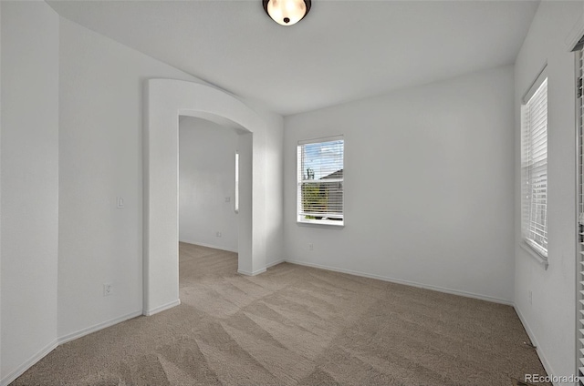 16043 Bridle Ridge Dr, Monument, CO 80132 - carpeted empty room with arched walkways and baseboards