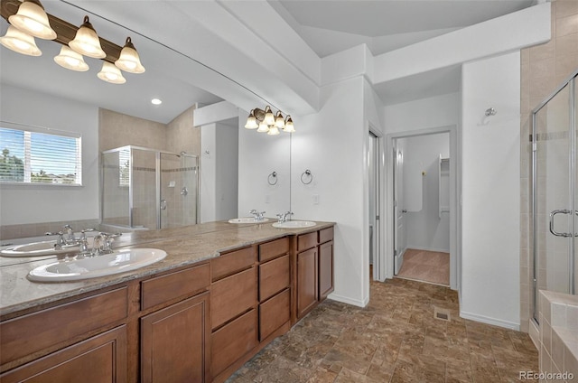 16043 Bridle Ridge Dr, Monument, CO 80132 - bathroom featuring a stall shower, double vanity, and stone finish flooring