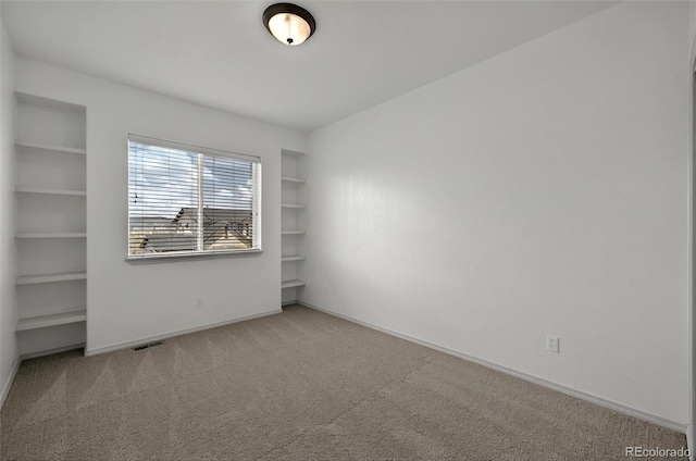 16043 Bridle Ridge Dr, Monument, CO 80132 - carpeted empty room featuring built in features and baseboards
