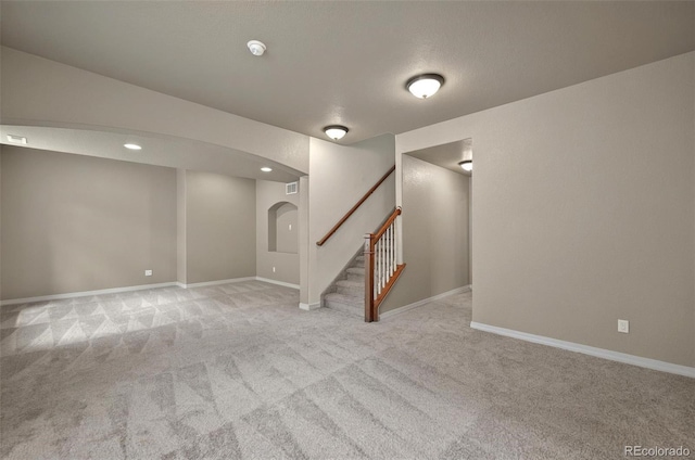 16043 Bridle Ridge Dr, Monument, CO 80132 - finished basement featuring carpet, stairs, arched walkways, baseboards, and recessed lighting