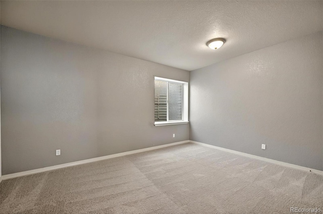 16043 Bridle Ridge Dr, Monument, CO 80132 - empty room with carpet, baseboards, and a textured ceiling