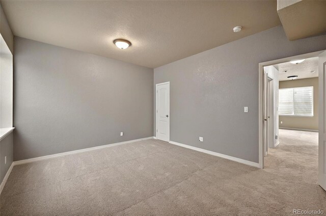 16043 Bridle Ridge Dr, Monument, CO 80132 - carpeted empty room with a textured ceiling, baseboards, and a smoke detector
