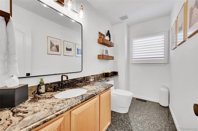 8427 S Parfet Ct, Littleton, CO 80127 - bathroom with vanity, toilet, and baseboards