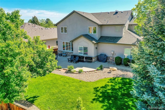 8427 S Parfet Ct, Littleton, CO 80127 - rear view of house with stucco siding, a patio, stone siding, and roof with shingles
