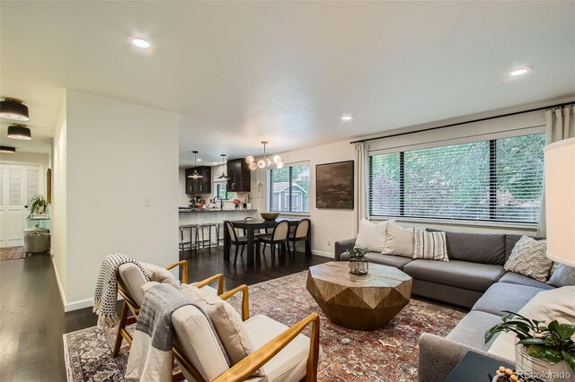 7036 Robb St, Arvada, CO 80004 - living room with a chandelier, dark wood finished floors, and recessed lighting