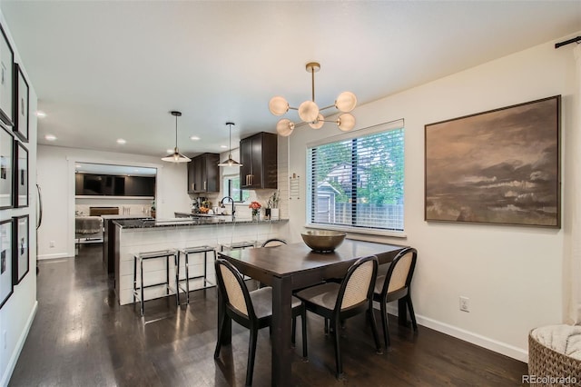 7036 Robb St, Arvada, CO 80004 - dining area featuring dark wood-style floors, recessed lighting, and a chandelier