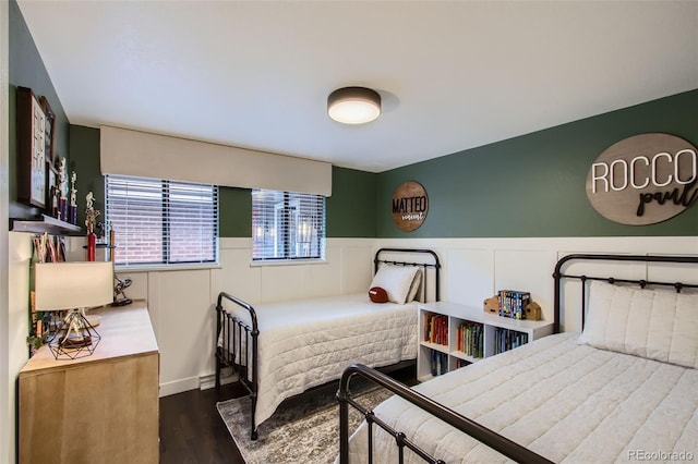 7036 Robb St, Arvada, CO 80004 - bedroom with dark wood-style flooring and a wainscoted wall