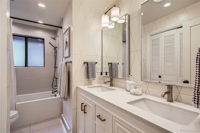 7036 Robb St, Arvada, CO 80004 - full bathroom with tile walls, double vanity, shower / washtub combination, tasteful backsplash, and recessed lighting