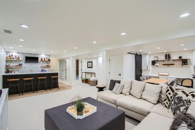 7036 Robb St, Arvada, CO 80004 - living room featuring a barn door, bar, and recessed lighting