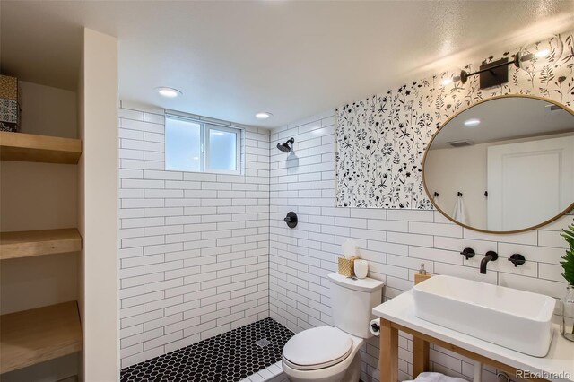 7036 Robb St, Arvada, CO 80004 - full bathroom with a tile shower, tile walls, and recessed lighting