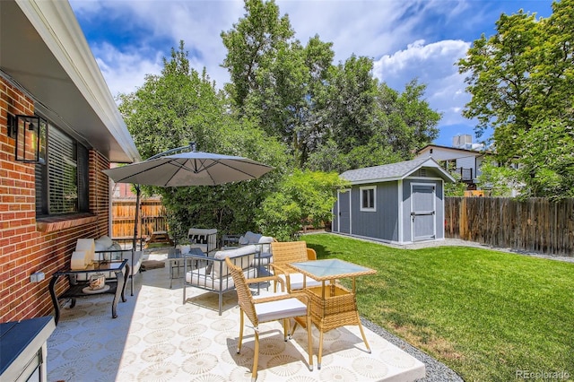 7036 Robb St, Arvada, CO 80004 - fenced backyard with a patio area, a storage unit, and outdoor lounge area