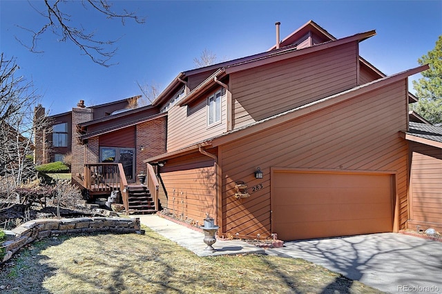 view of front of property featuring aphalt driveway and an attached garage