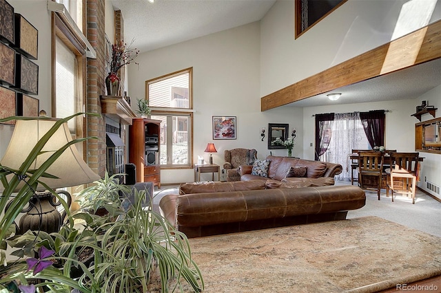 living area featuring carpet floors, a wealth of natural light, and a towering ceiling