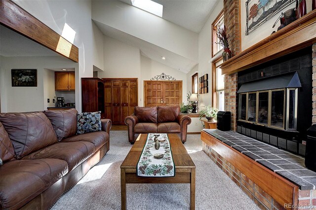 carpeted living room with high vaulted ceiling and a brick fireplace