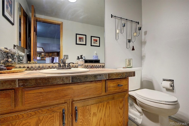 bathroom featuring toilet and vanity