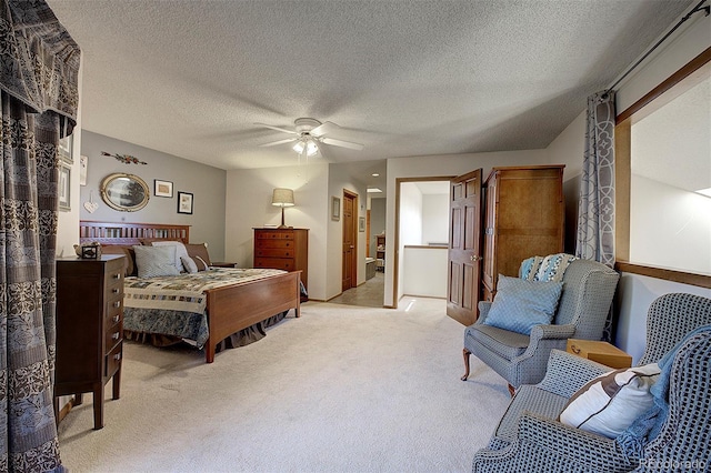 bedroom with a textured ceiling, a ceiling fan, and light colored carpet