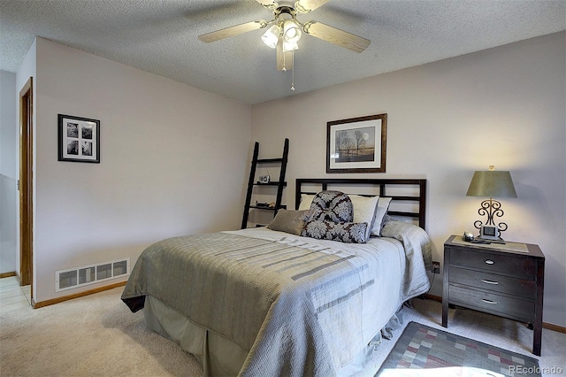 bedroom featuring baseboards, visible vents, ceiling fan, a textured ceiling, and carpet floors